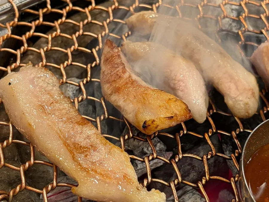 Black pork cooking on the grill