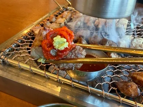 Cooked mokssal placed at the edge of the grill