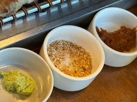 Piece of black pork mokssal topped with mu-saengchae and wasabi