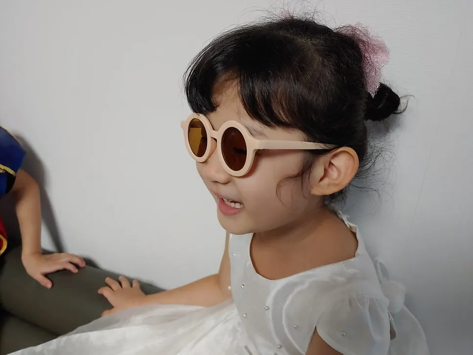 Child wearing children’s sunglasses