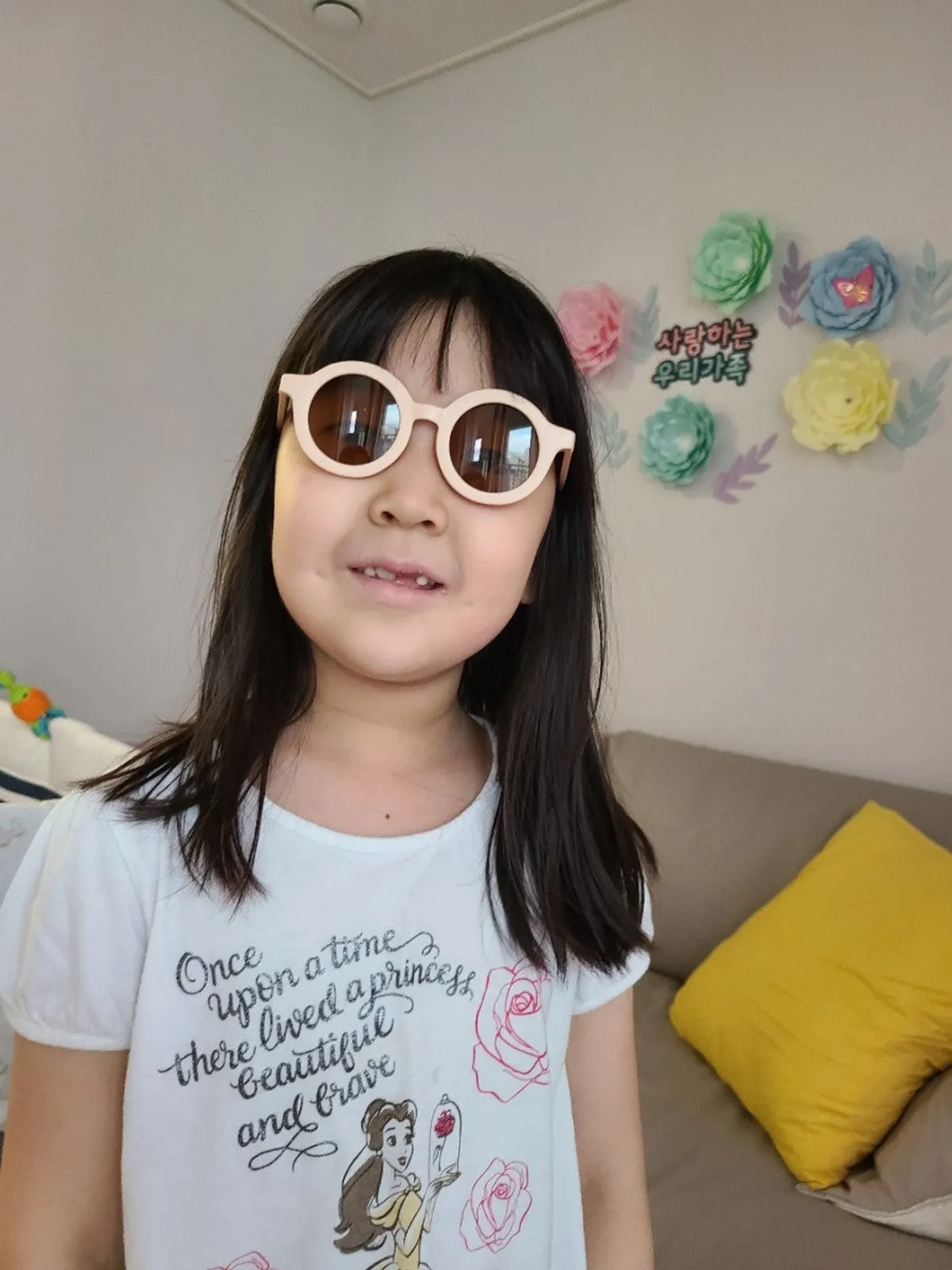 Child happily wearing children’s sunglasses