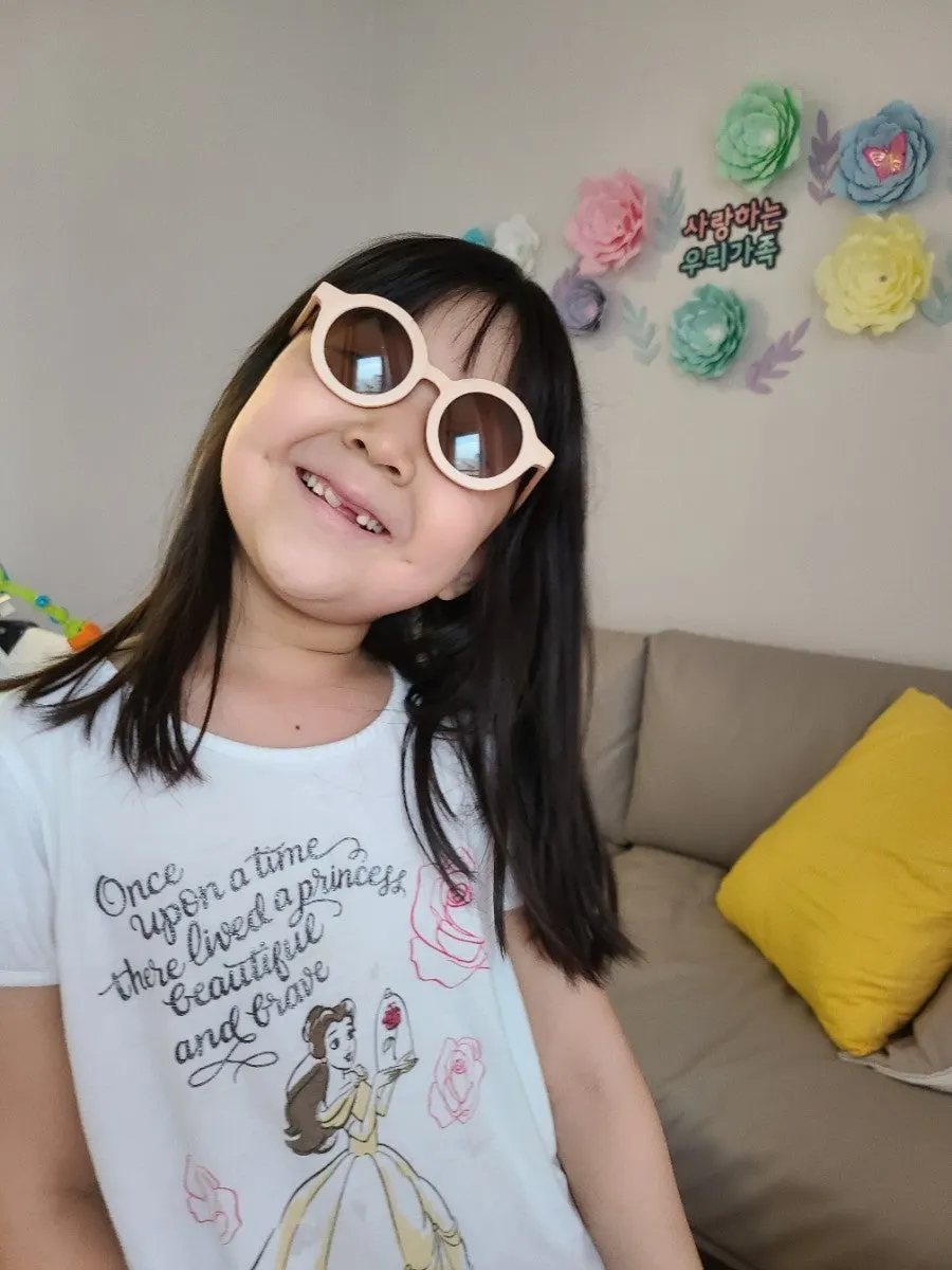 Child happily wearing Greg & Co sunglasses