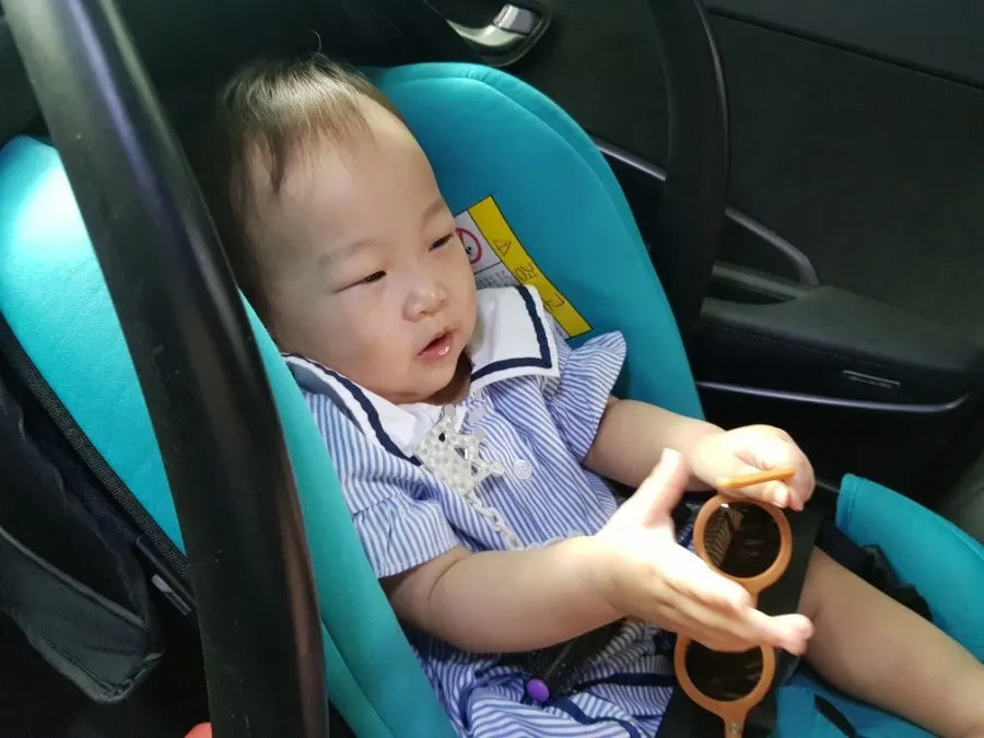 12-month-old sibling wearing sunglasses