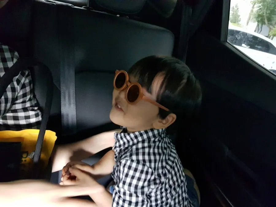 Younger sibling touching sunglasses