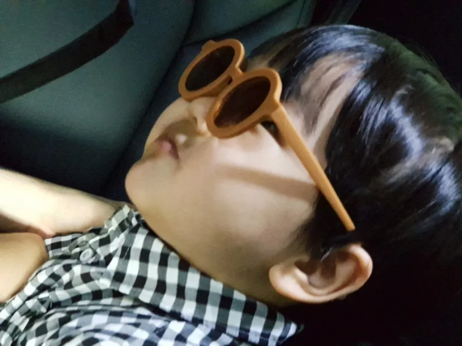 Child playing while wearing sunglasses