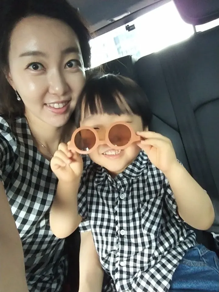 Child wearing sunglasses upside down