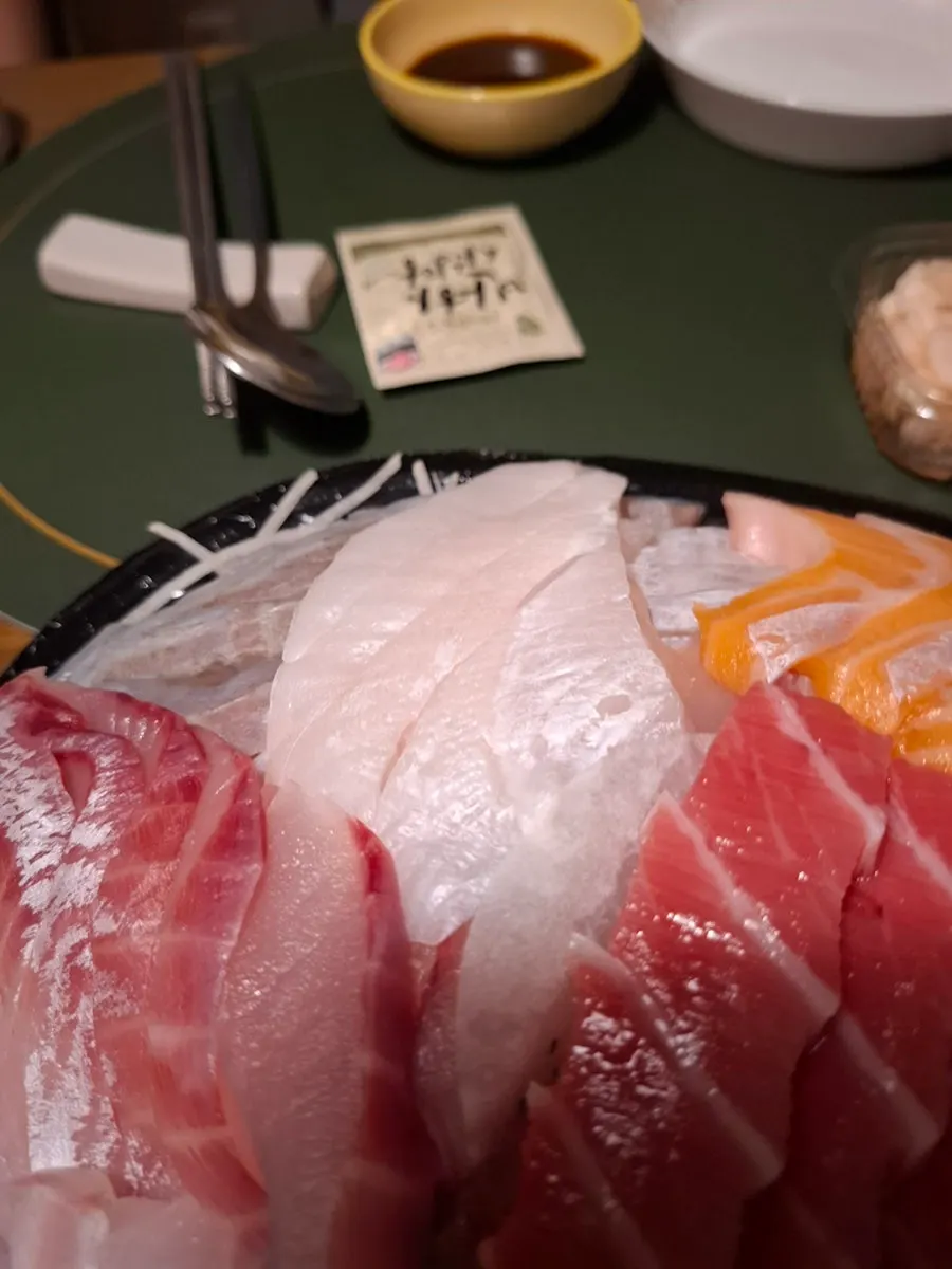 A piece of olive flounder sashimi