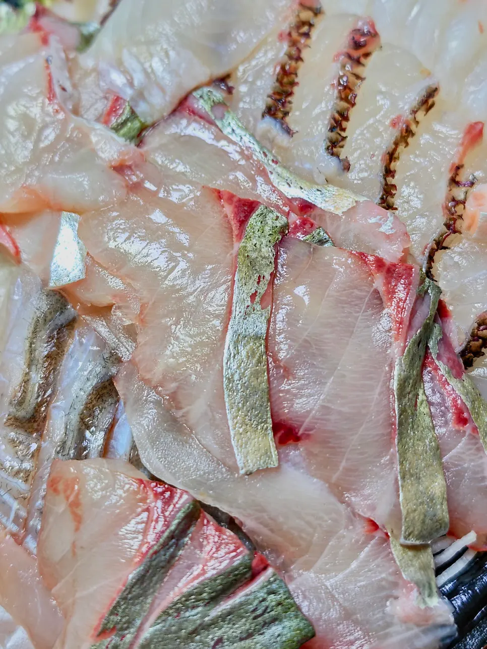 A single piece of homemade live-fish sashimi sushi