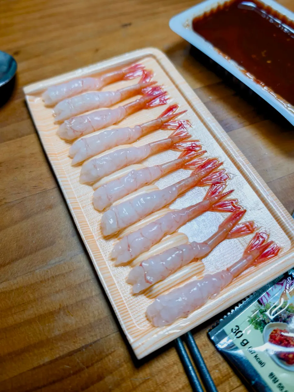Leftover sashimi still on the plate after four people ate their fill
