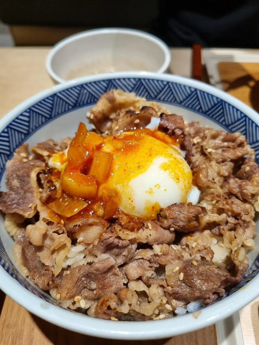 A bite of yukhoe-don wrapped in seaweed