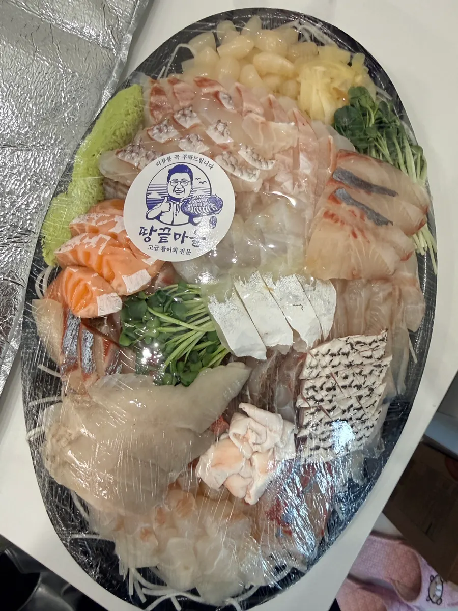 A generous sashimi takeaway on a housewarming table
