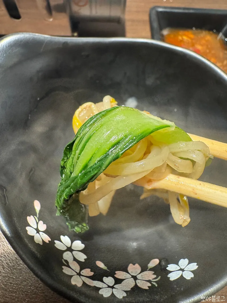 A piece of sukiyaki meat dipped in raw egg