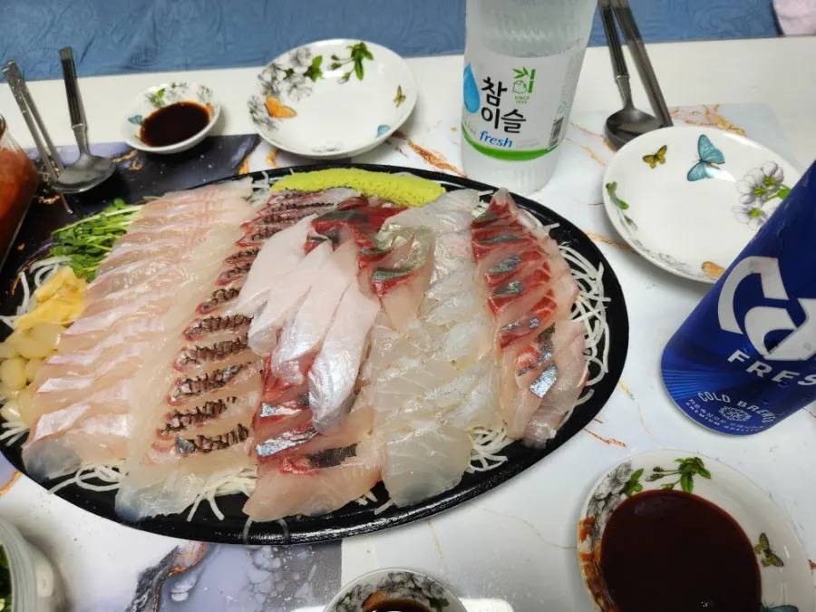 Sashimi platter laid out at home with sauces and sides