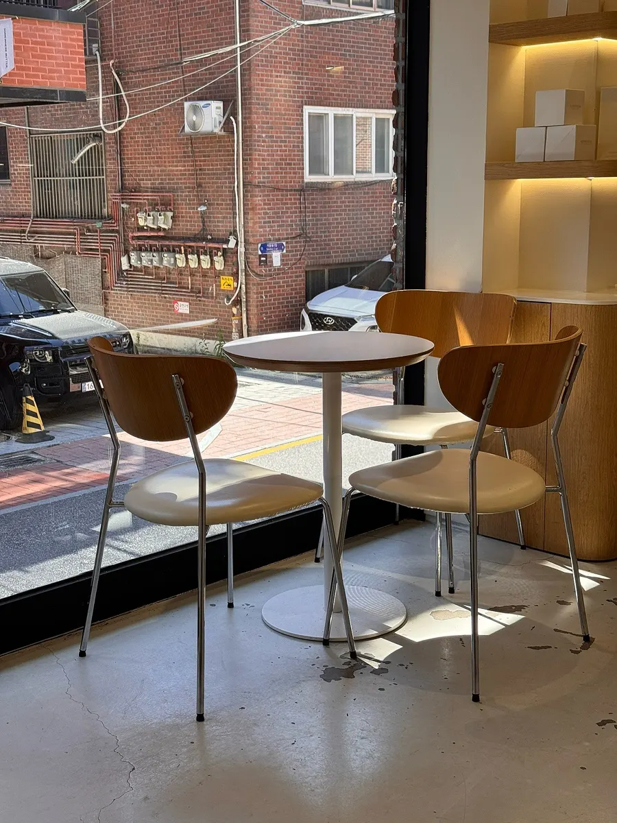 Café seating with sunlight streaming through floor-to-ceiling windows