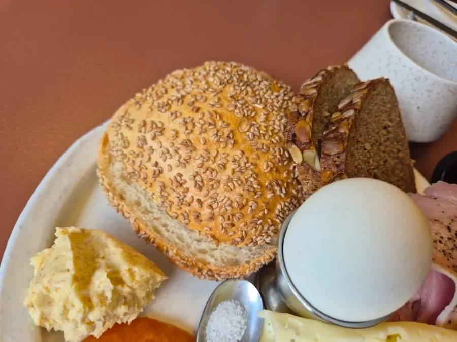 Plate with soft-boiled egg, house-made jamón, and havarti cheese