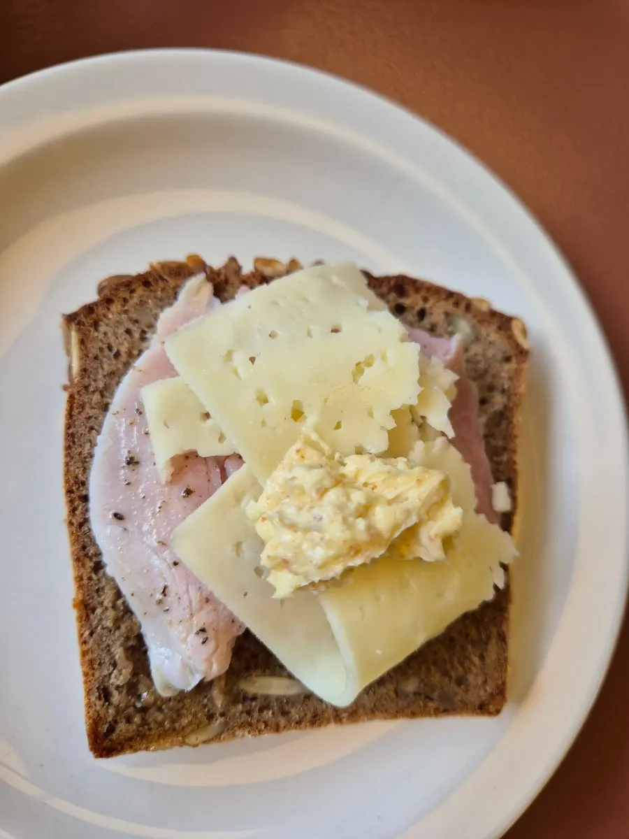 A slice of bread spread with peach jam