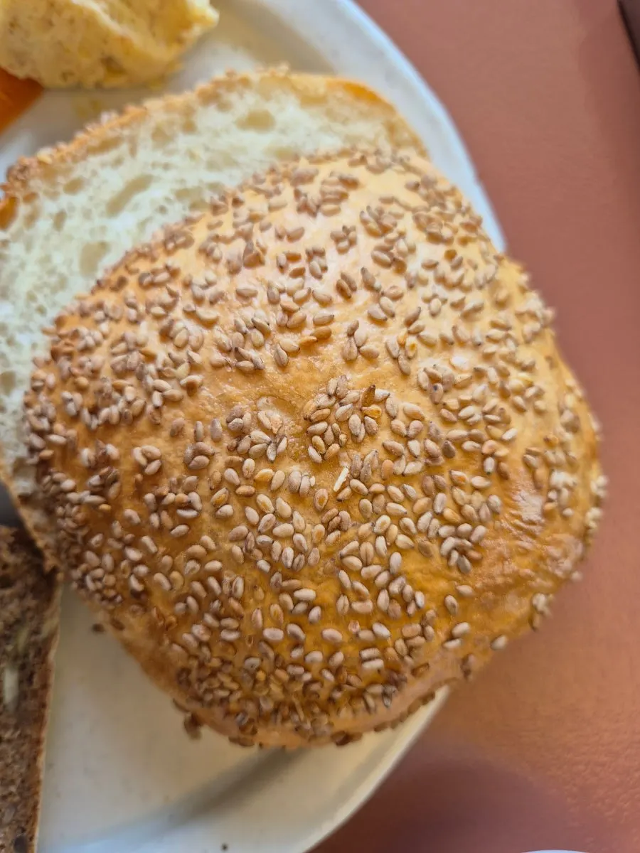 Cross-section of dense, chewy rye bread full of nuts