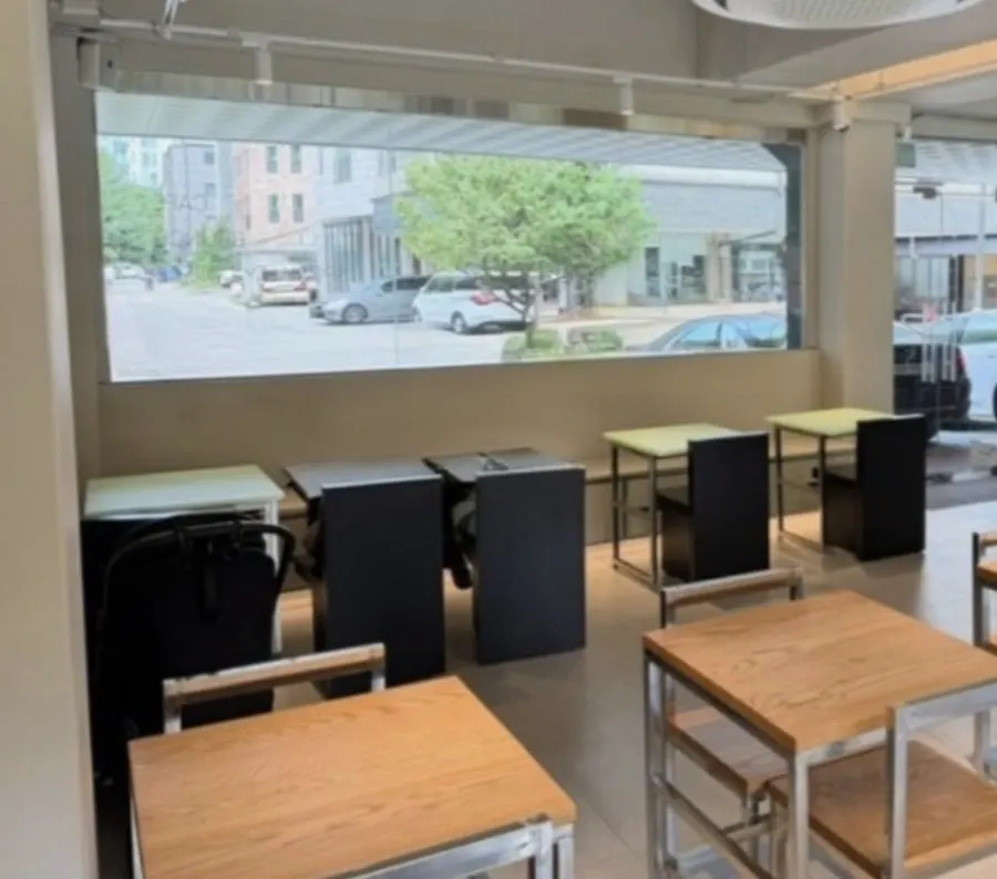 U-shaped table by the window wall with outlets underneath