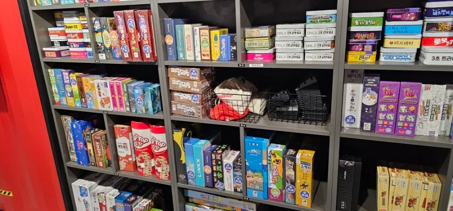 Shelves filled with a variety of board games
