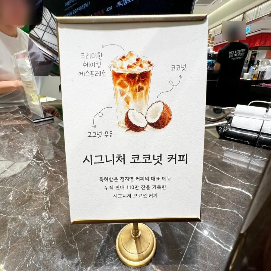Menu board listing the signature coconut coffee