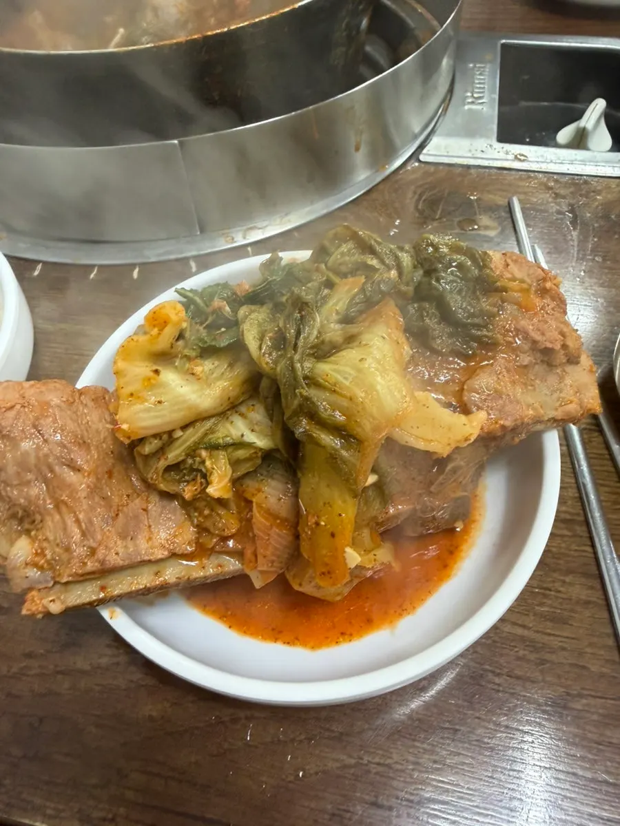Rich gamjatang broth and a large bone