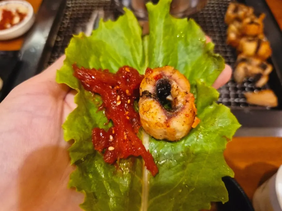 A piece of eel topped with shredded ginger