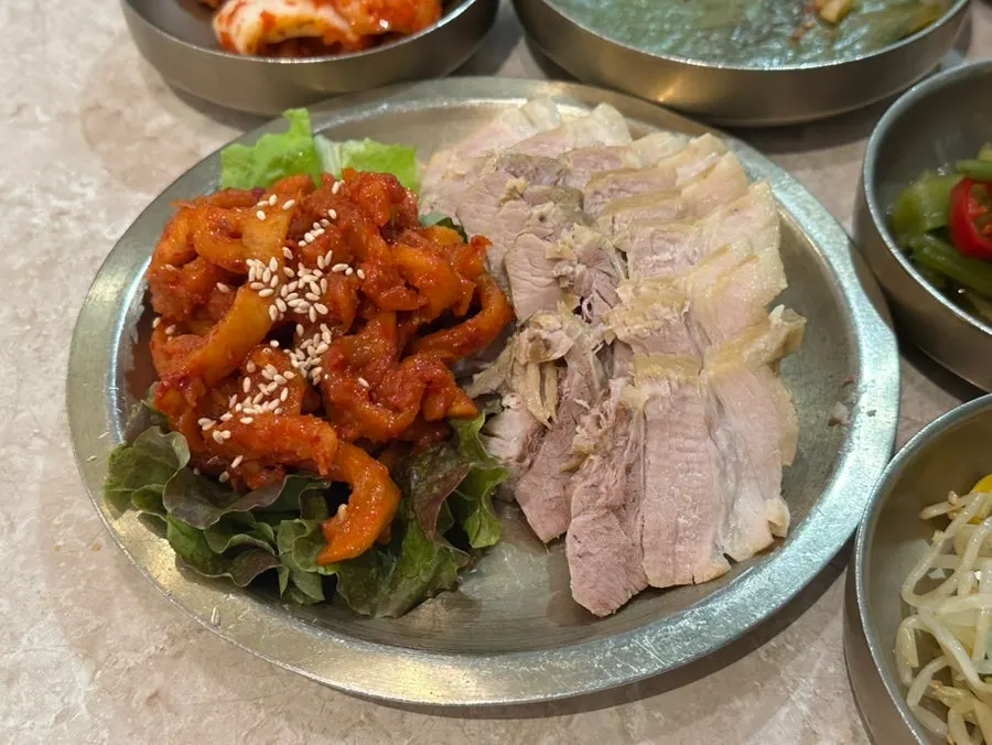 Table setting with bossam, hanwoo radish rice, and chogye guksu
