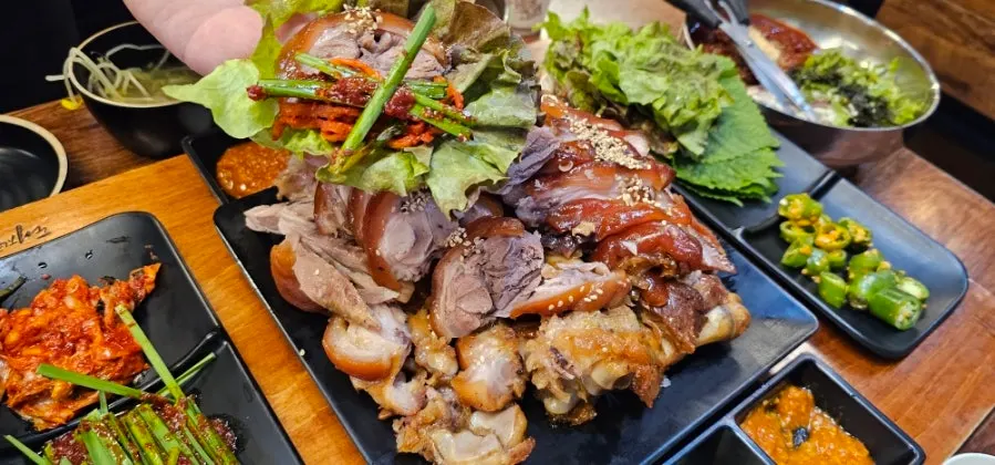 Scene of wrapping jokbal in lettuce