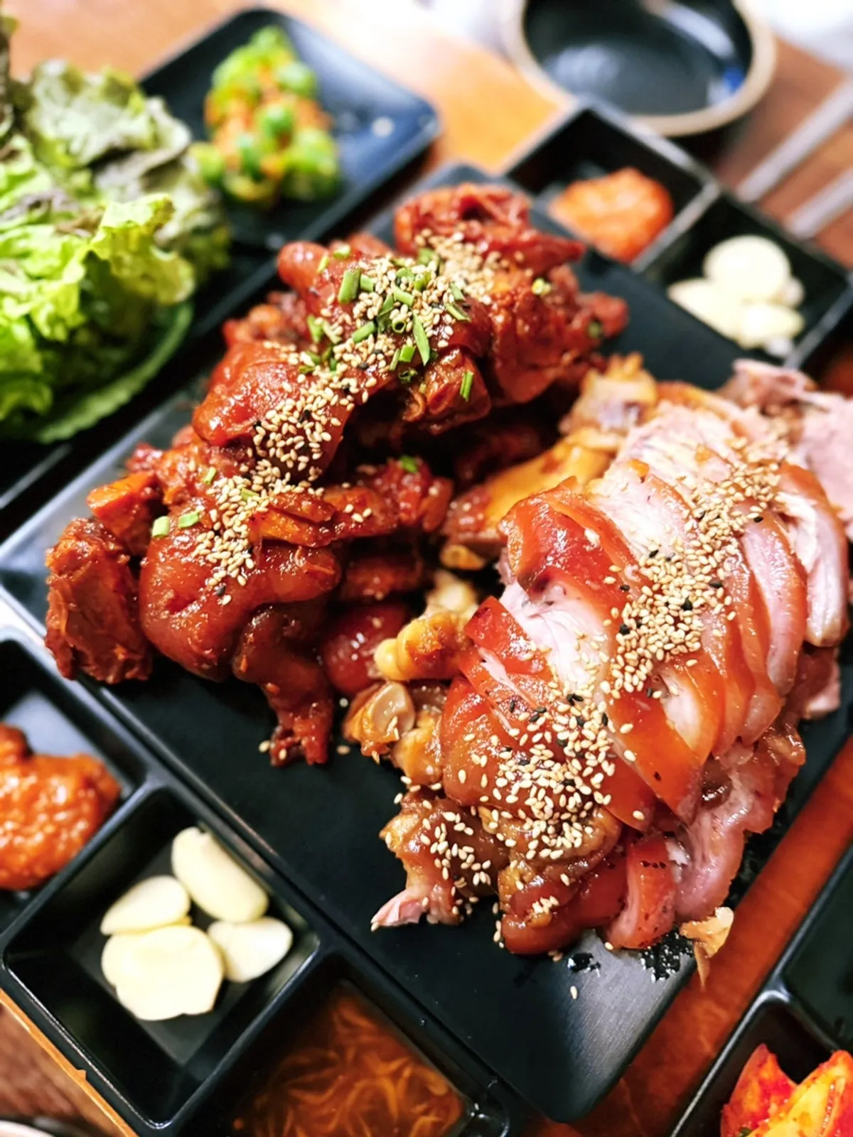 Half-and-half plate of spicy grilled jokbal and plain jokbal