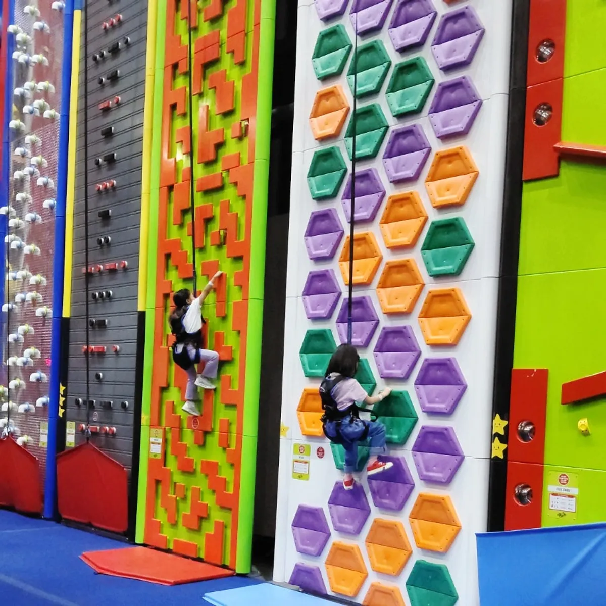 A child climbing the wall at Jump Adventure's Climb zone