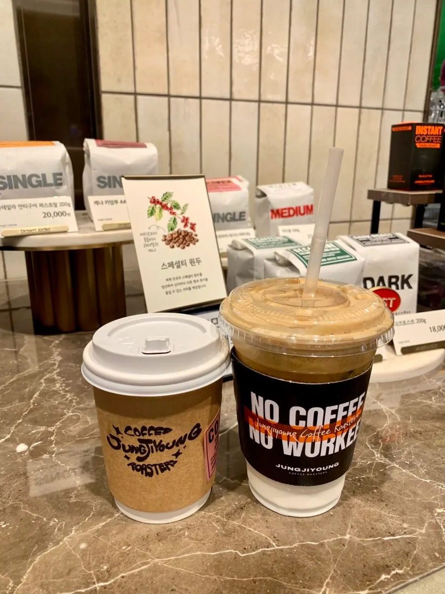 Two cups: the ordered coconut coffee and drip coffee