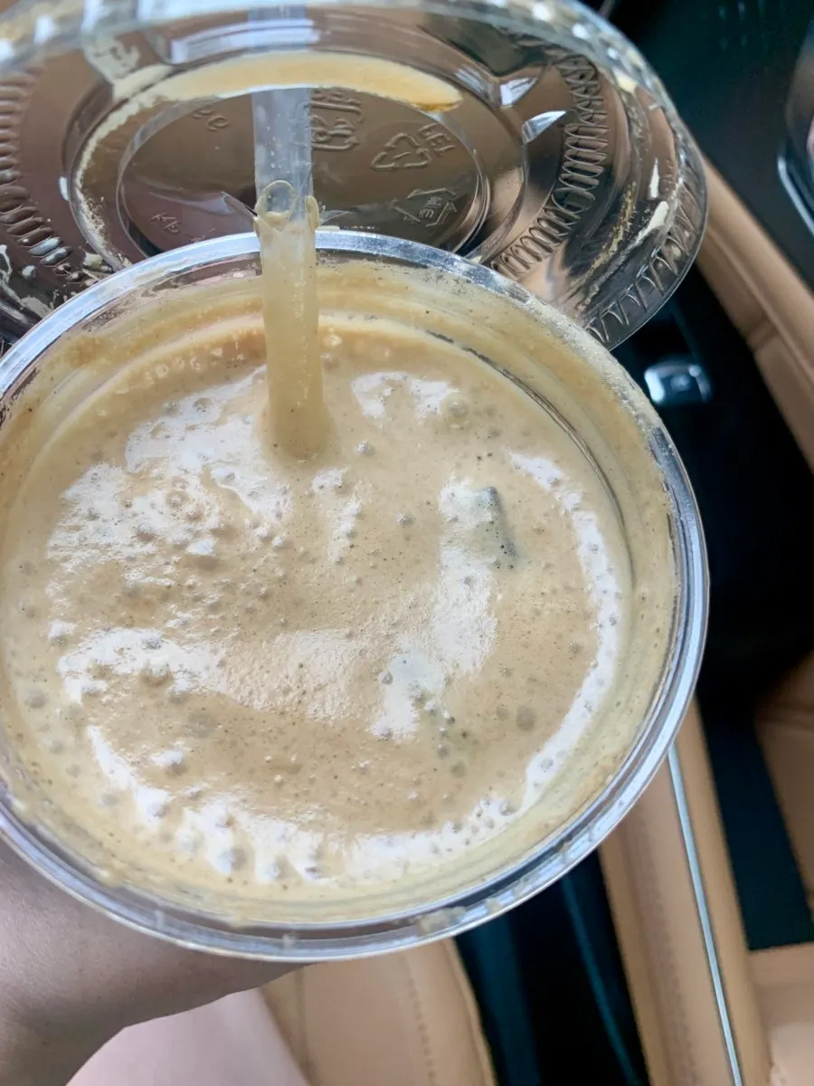 Close-up of coconut coffee showing the creamy espresso
