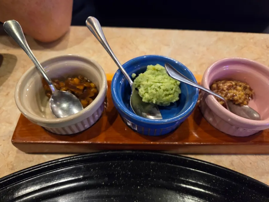Side dishes and sauces laid out after ordering