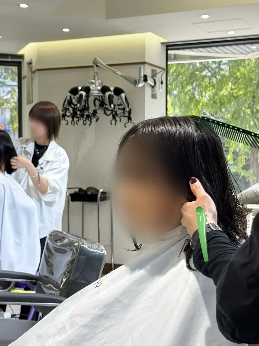 Designer cutting the child's hair