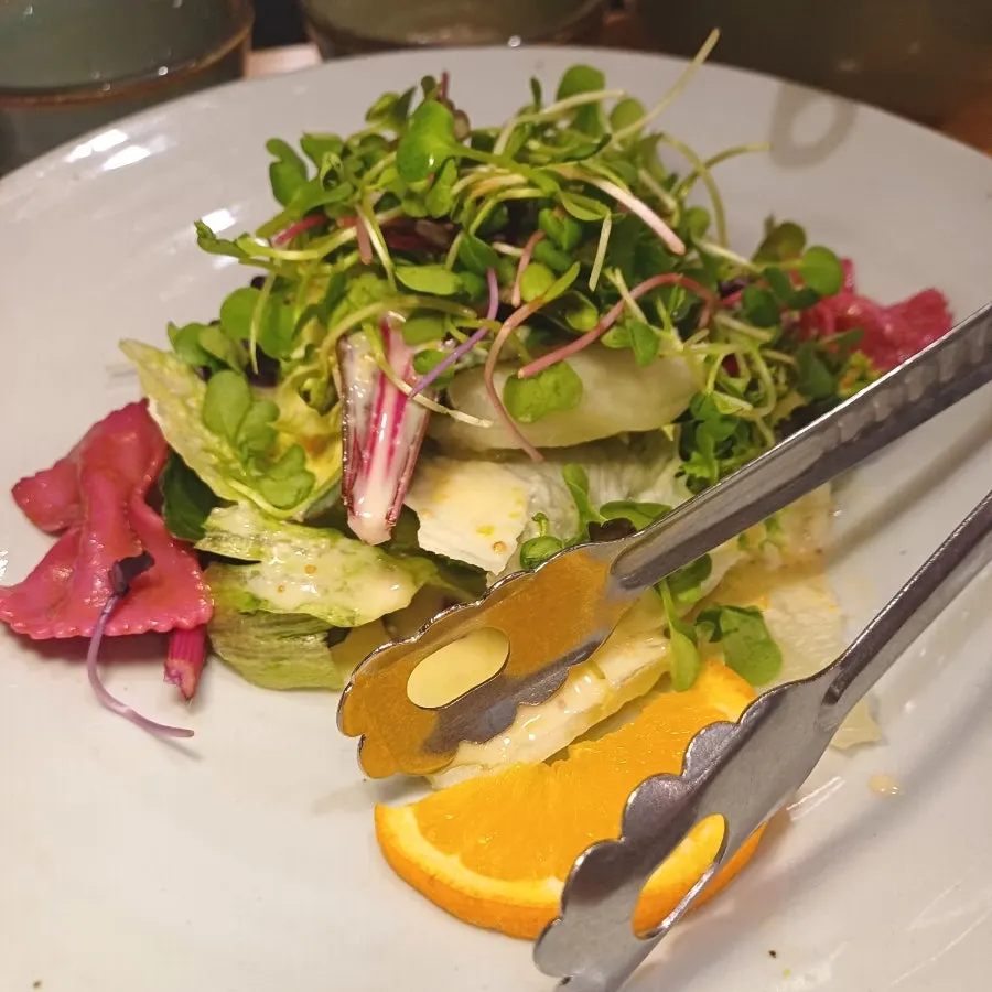 Orange butterfly salad topped with a butterfly-shaped pasta piece