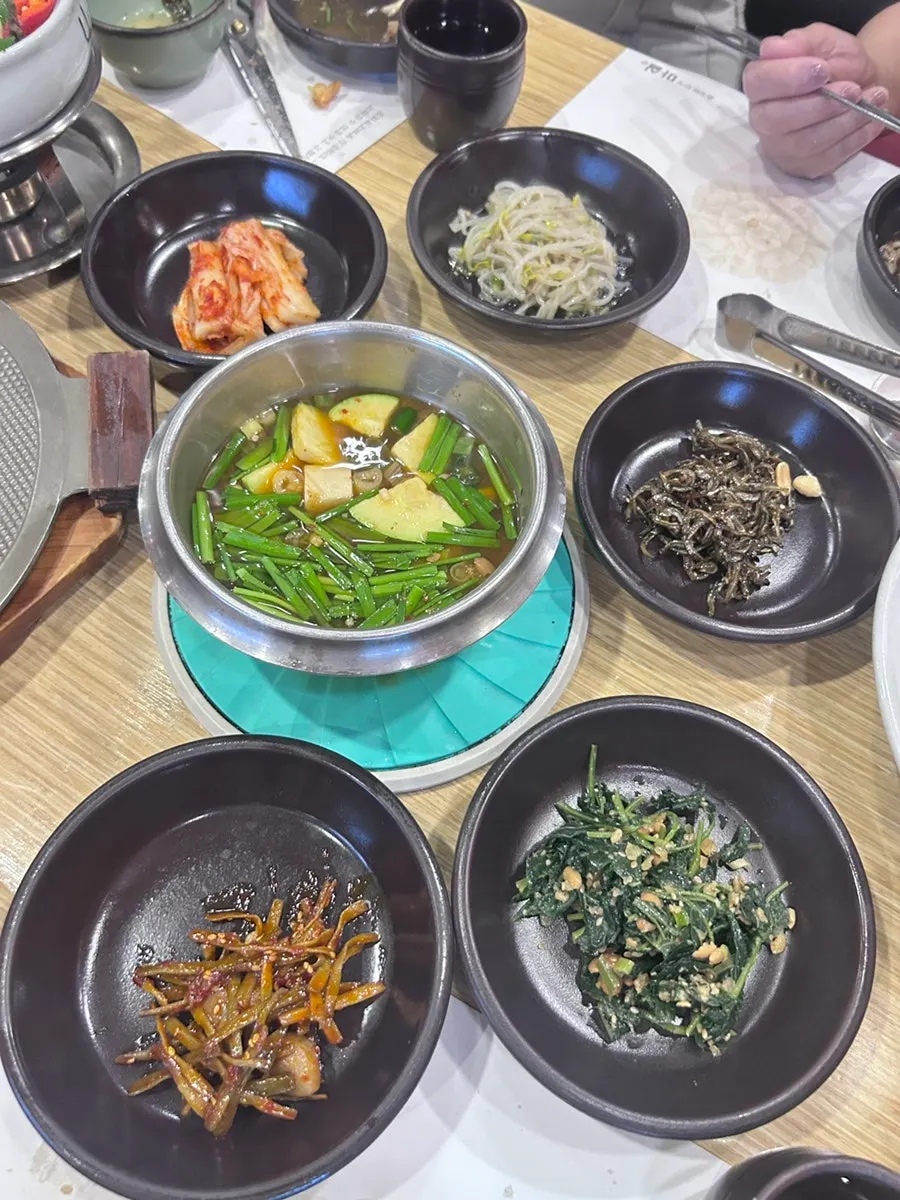 Tteokgalbi and onions on a tabletop induction burner