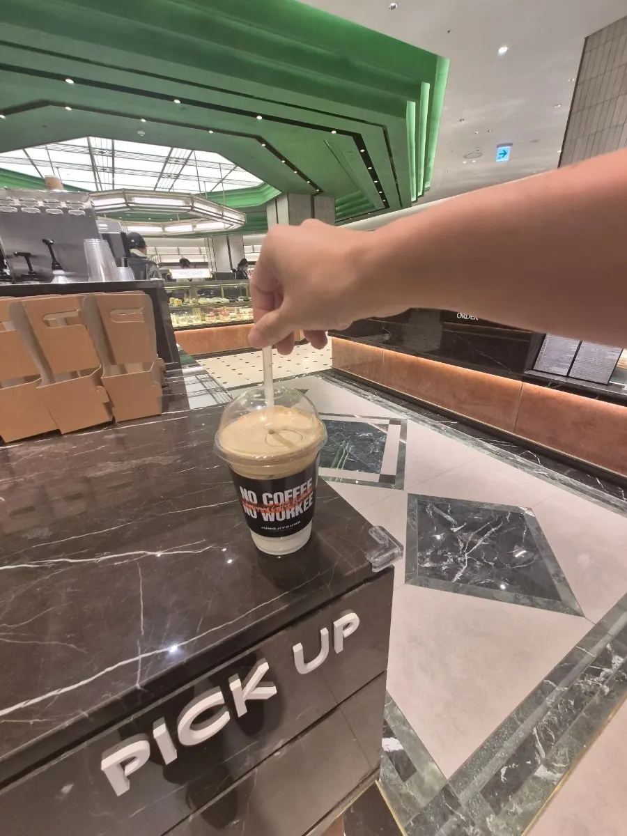 Signature coconut coffee sitting on the pickup counter