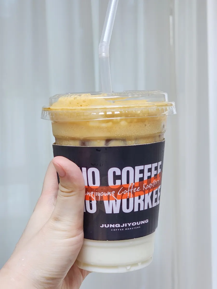 A cup of coconut coffee with milk and espresso shot separated