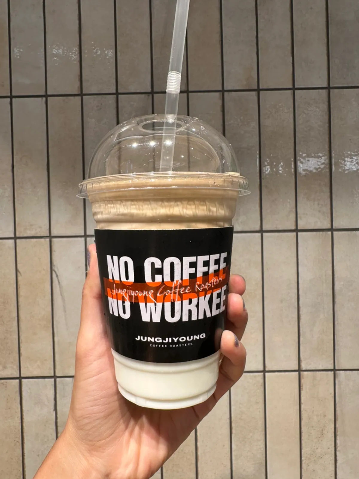 Disposable cup of coconut coffee showing its two separate layers