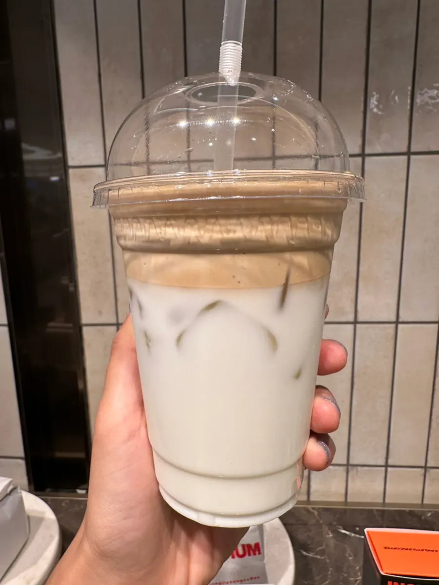 Holding two cups of coconut coffee
