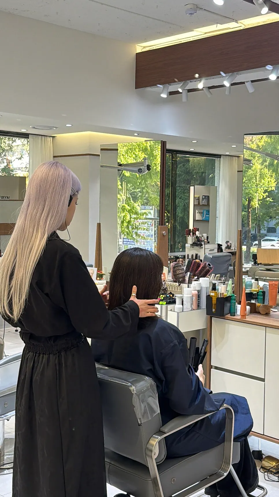 Hair salon interior with large windows and trees in view