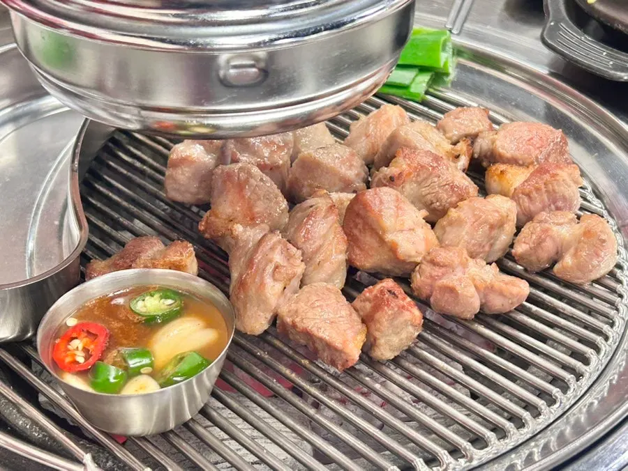 Owner cutting pork collar into perfect portions