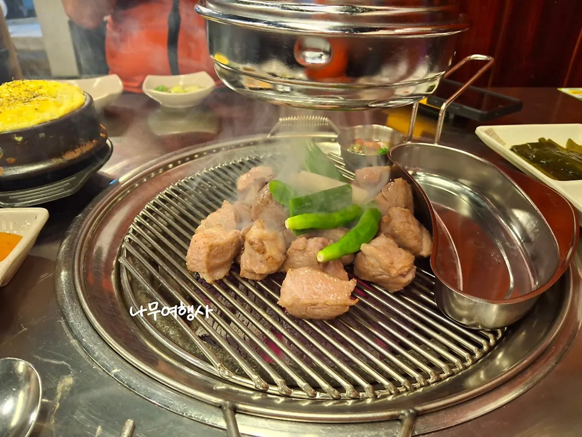Pork neck grilled over charcoal at Moksam Hwaro