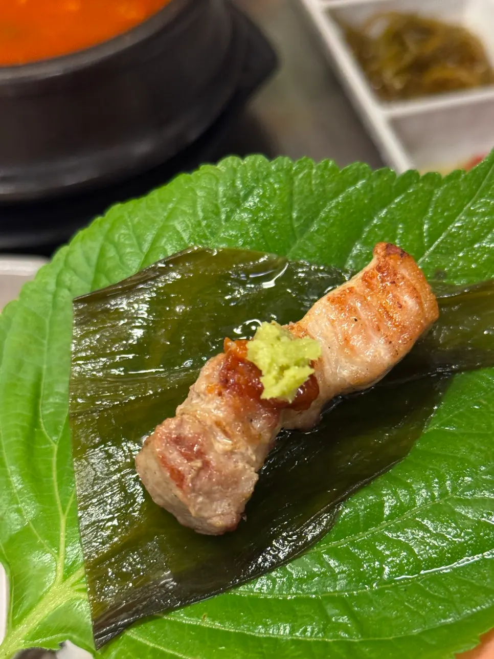 Pork belly with pickled garlic leaves and wasabi