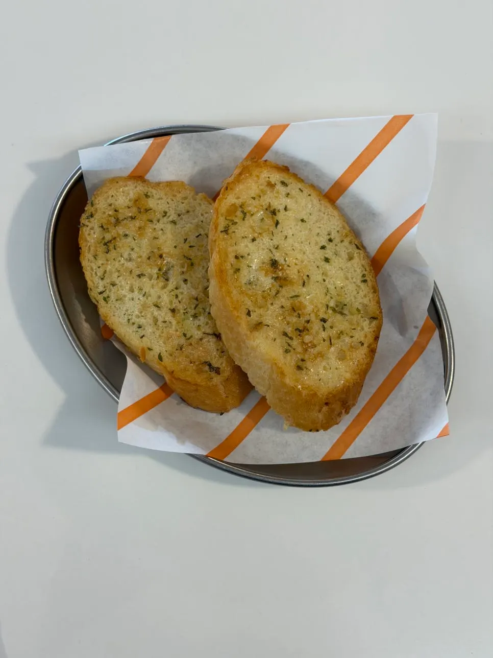 Garlic bread served before the meal, one per person