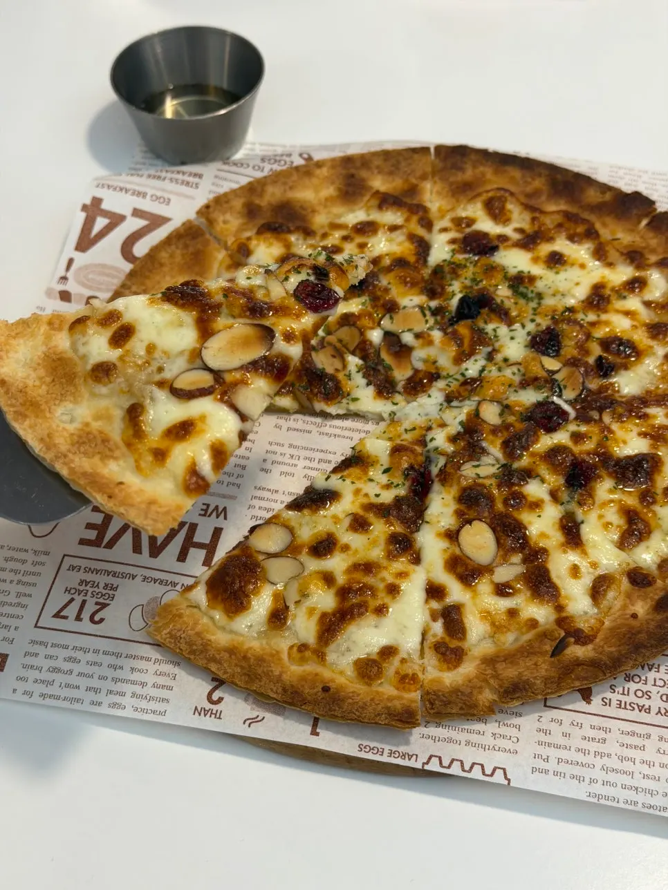 A slice of gorgonzola pizza with crisp baked edges