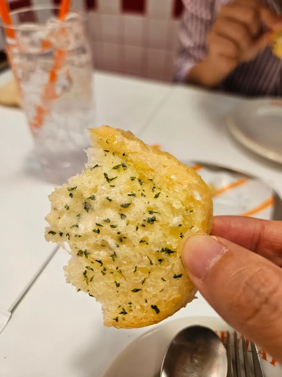 Close-up of warm bread drizzled with condensed milk