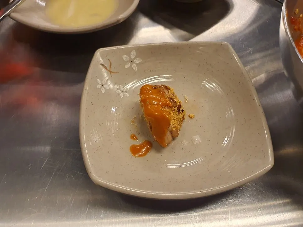 A piece of pork neck wrapped in myeong-i namul