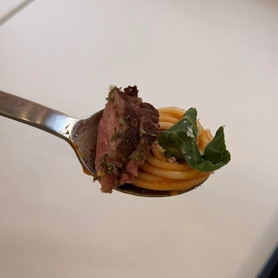 Steak and salad portioned into bite-sized pieces