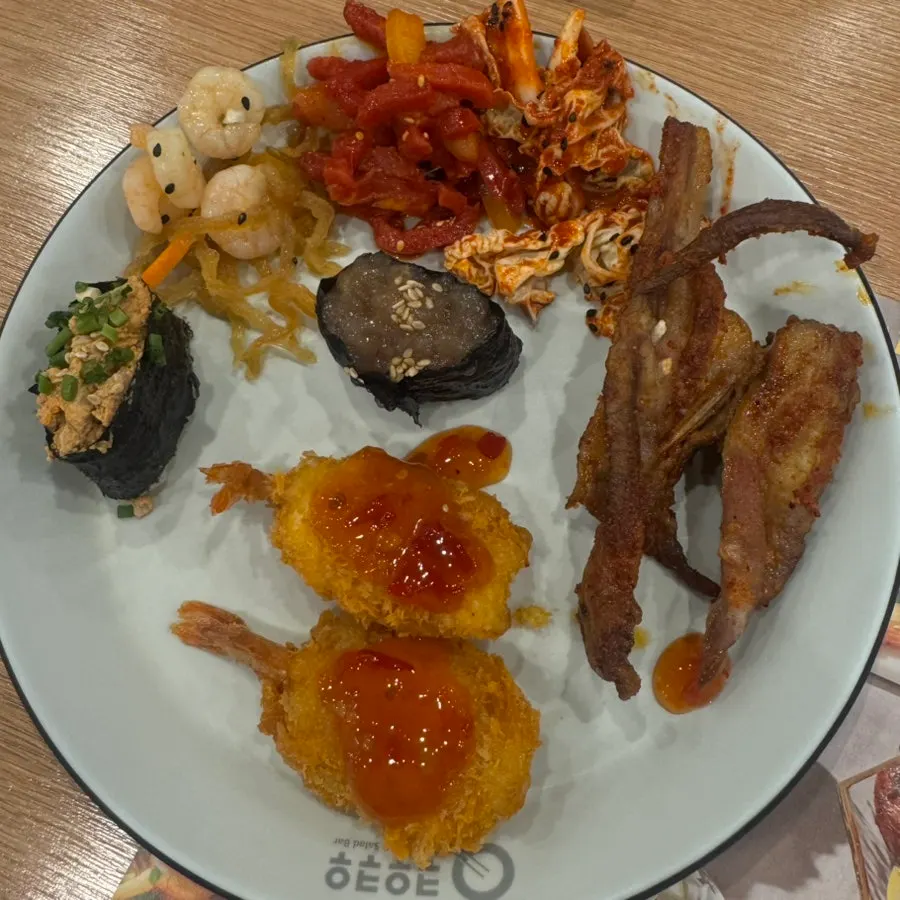 A plate of fried food, lamb chops, and yukhoe